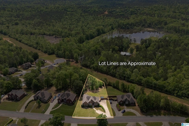drone / aerial view featuring a view of trees and a water view