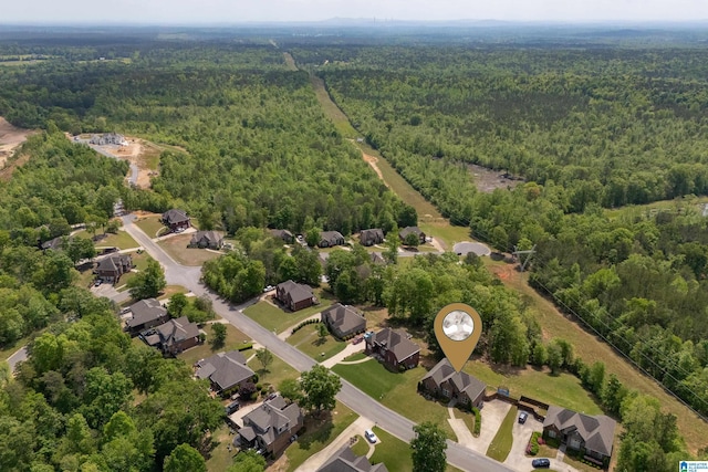 birds eye view of property featuring a residential view and a forest view