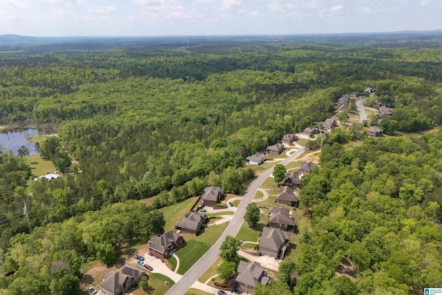 drone / aerial view featuring a residential view, a forest view, and a water view