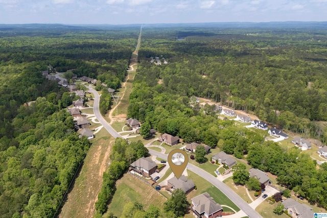 bird's eye view featuring a residential view and a wooded view