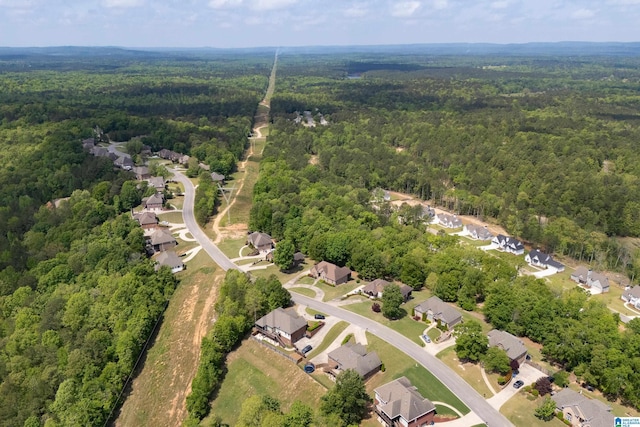 birds eye view of property featuring a residential view and a wooded view