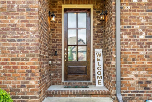 property entrance with brick siding