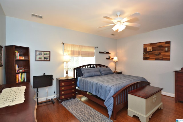bedroom with a ceiling fan, baseboards, visible vents, and wood finished floors