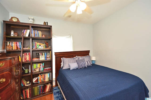 bedroom featuring a ceiling fan and wood finished floors