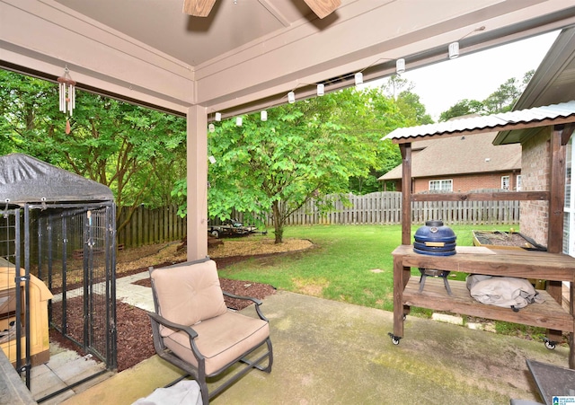 view of patio with a fenced backyard and ceiling fan