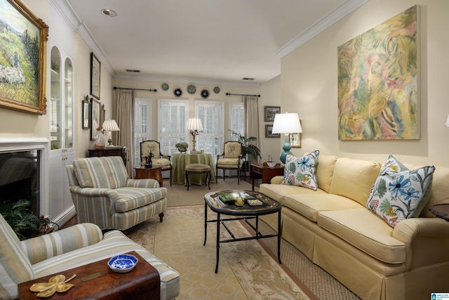 living area featuring crown molding, light colored carpet, and a fireplace