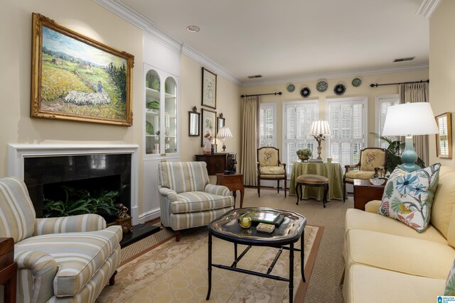 living room featuring ornamental molding, visible vents, and carpet