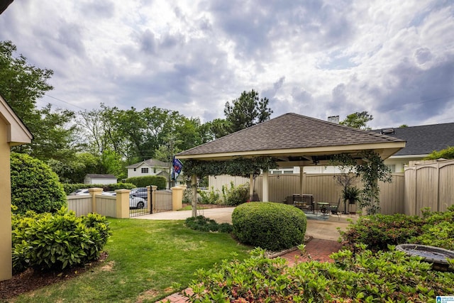 view of yard with a patio area, a gazebo, fence private yard, and a gate