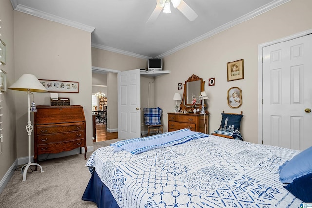 carpeted bedroom with baseboards, a ceiling fan, and crown molding