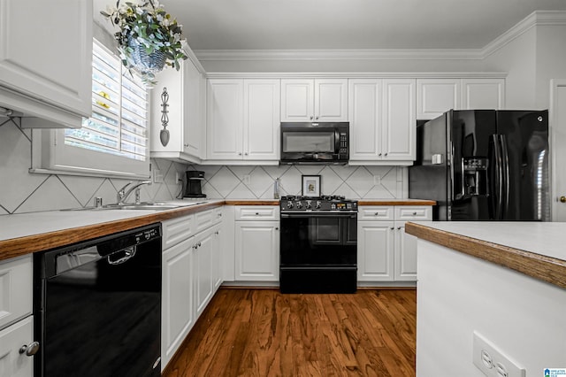 kitchen with white cabinetry, black appliances, dark wood finished floors, and a sink