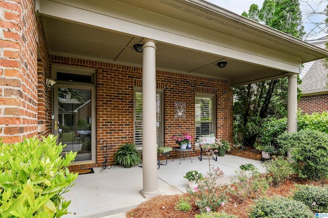 doorway to property with brick siding