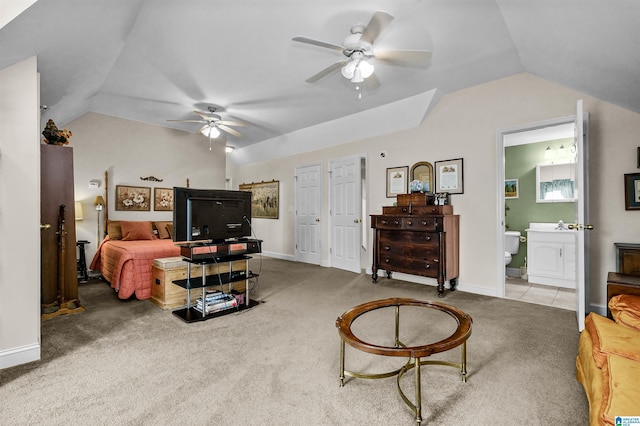carpeted bedroom with lofted ceiling, ensuite bathroom, a ceiling fan, and baseboards