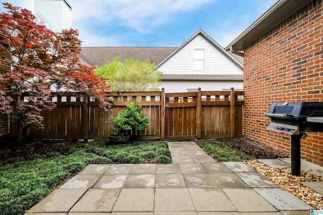 view of patio featuring fence and area for grilling