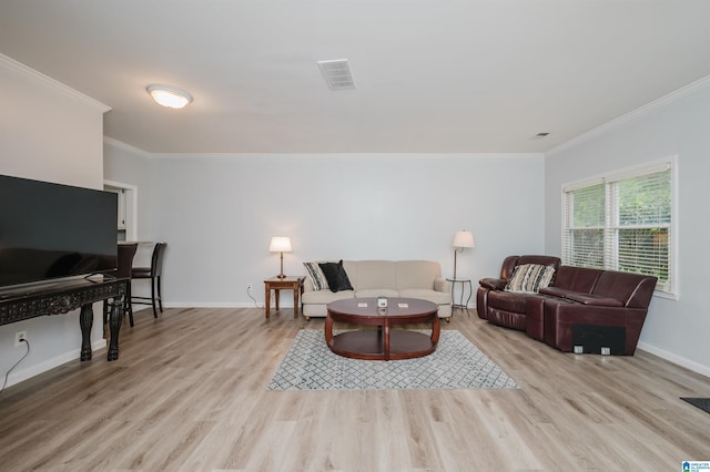 living area featuring baseboards, ornamental molding, and wood finished floors