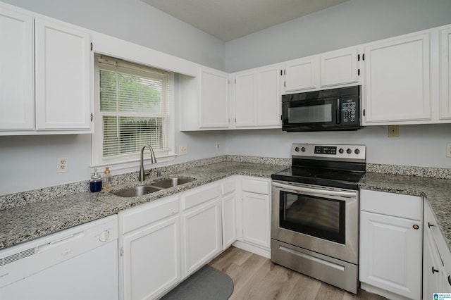 kitchen featuring black microwave, white cabinetry, stainless steel electric stove, a sink, and dishwasher