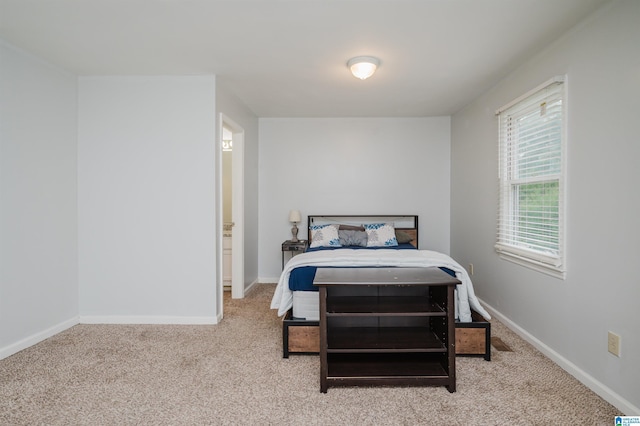bedroom with baseboards and carpet flooring