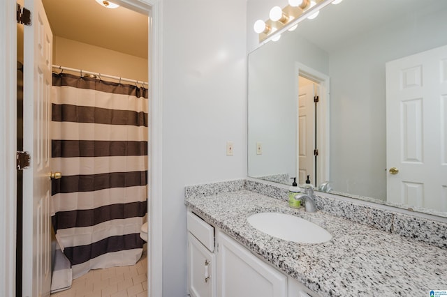 bathroom with vanity, toilet, and a shower with curtain