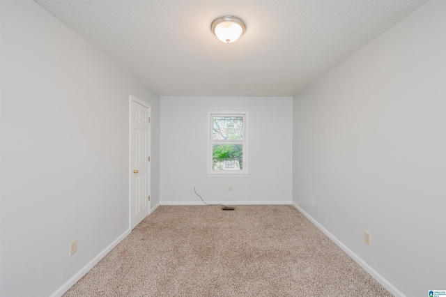 carpeted empty room with baseboards