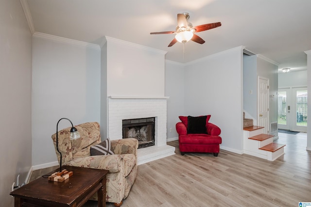 living area with ceiling fan, ornamental molding, and light wood-style flooring
