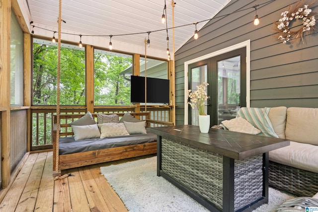 sunroom featuring a healthy amount of sunlight, french doors, and an outdoor living space
