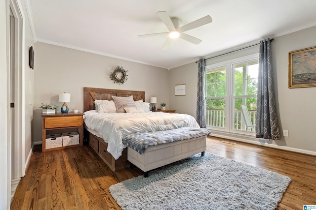 bedroom with baseboards, ornamental molding, a ceiling fan, and wood finished floors