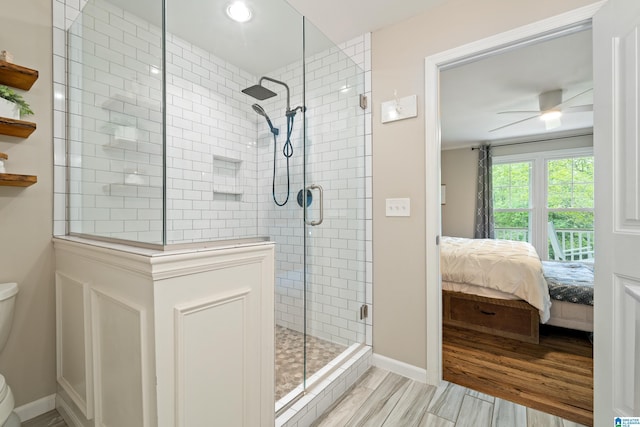 bathroom with baseboards, toilet, a shower stall, and connected bathroom