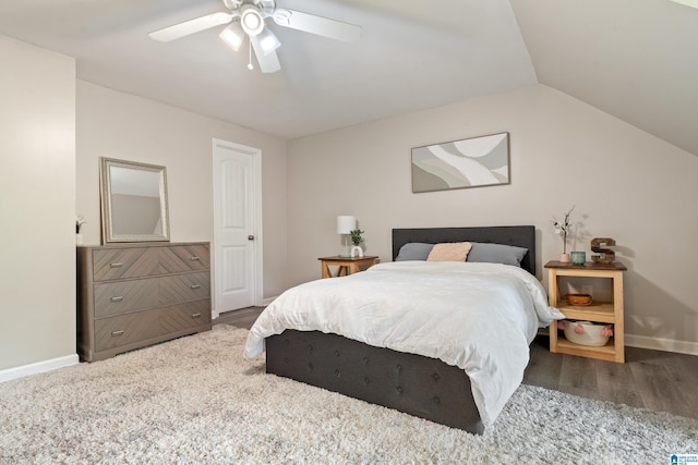 bedroom with a ceiling fan, wood finished floors, lofted ceiling, and baseboards