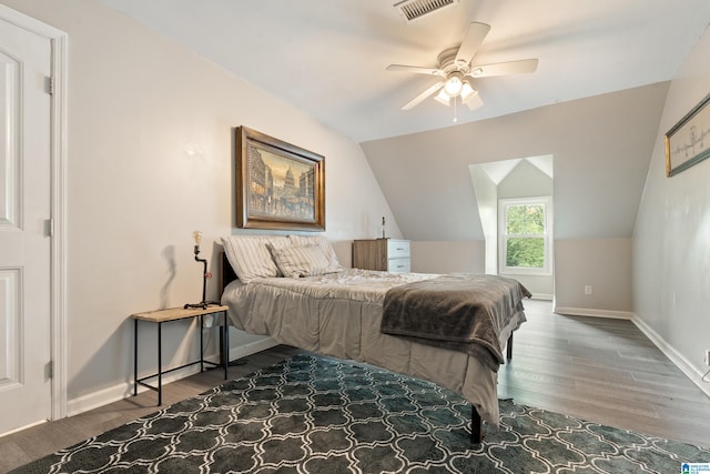bedroom featuring visible vents, wood finished floors, and lofted ceiling