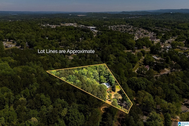 birds eye view of property with a wooded view