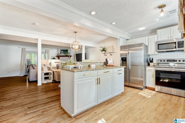 kitchen with visible vents, a textured ceiling, light wood-style floors, and appliances with stainless steel finishes