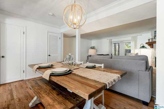 dining space featuring ornamental molding, an inviting chandelier, and light wood finished floors