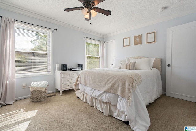 carpeted bedroom featuring a textured ceiling, ceiling fan, crown molding, and multiple windows