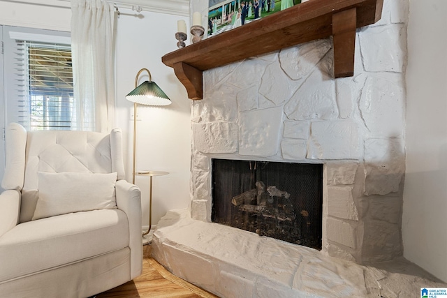 sitting room featuring a stone fireplace