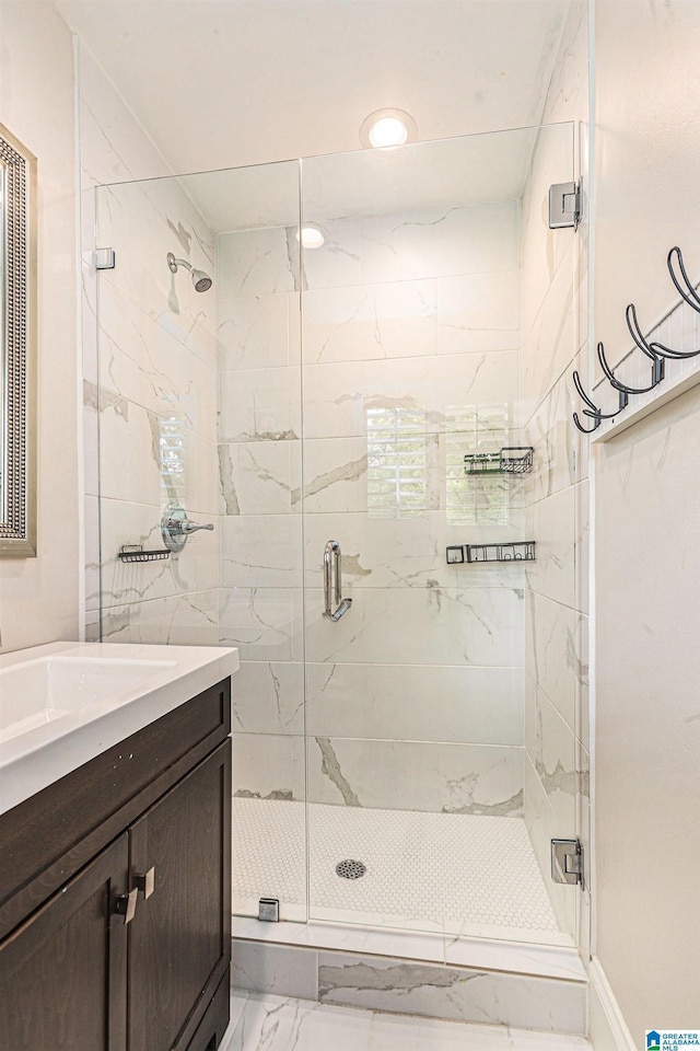 full bath featuring recessed lighting, a stall shower, vanity, and marble finish floor