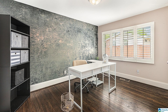 office area with baseboards, visible vents, and wood finished floors