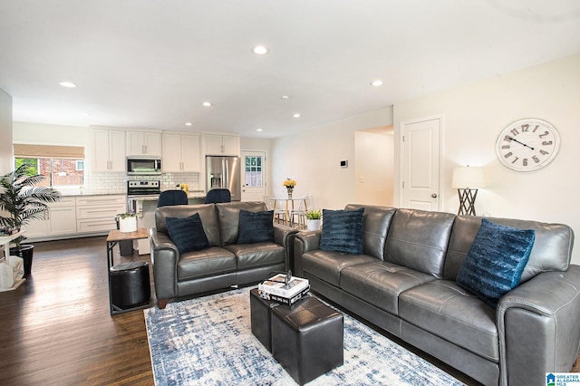 living area featuring dark wood-style floors and recessed lighting
