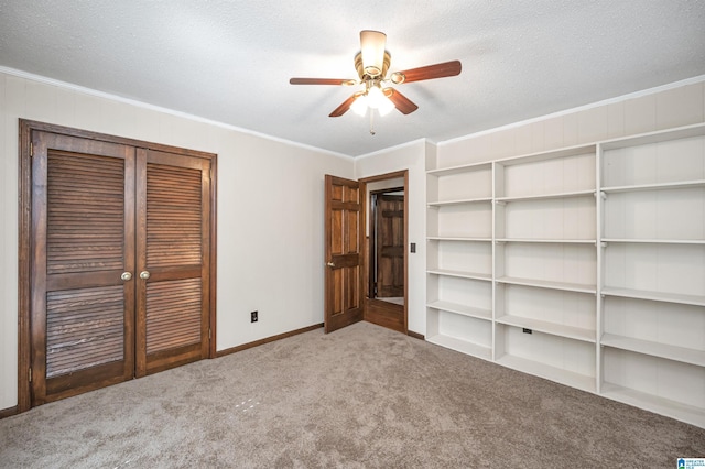 unfurnished bedroom featuring carpet flooring, a textured ceiling, and crown molding