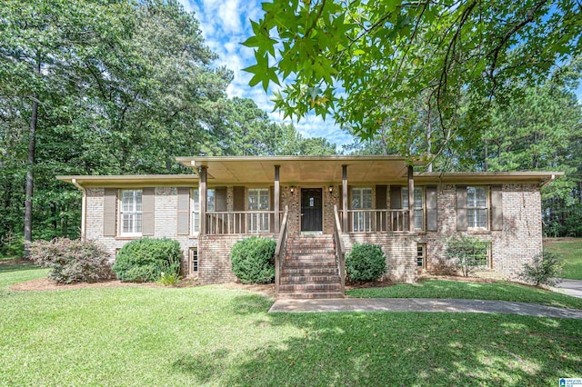 ranch-style home with brick siding, a porch, a front lawn, and stairway