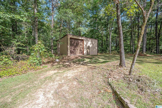view of outbuilding featuring an outbuilding and a forest view