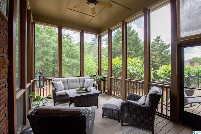 sunroom / solarium featuring ceiling fan and an outdoor living space