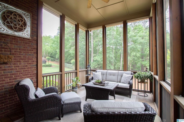 sunroom featuring a ceiling fan and outdoor lounge area