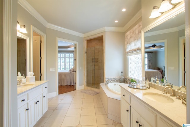 ensuite bathroom featuring a bath, two vanities, a shower stall, crown molding, and tile patterned flooring