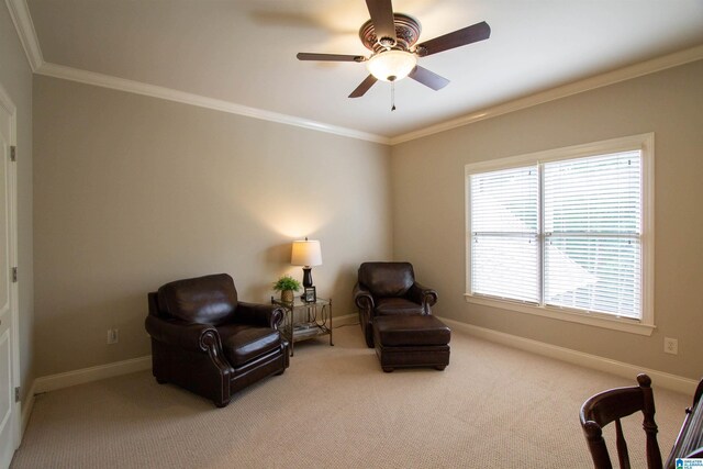 living area with crown molding, carpet floors, baseboards, and ceiling fan