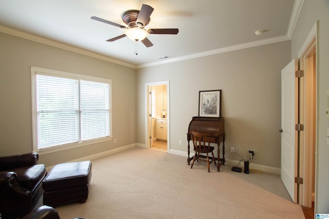 sitting room with ornamental molding, a ceiling fan, light carpet, and baseboards