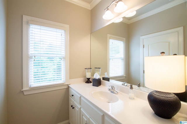bathroom with ornamental molding, vanity, and baseboards