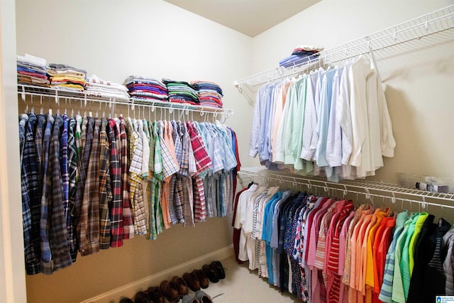 walk in closet with carpet