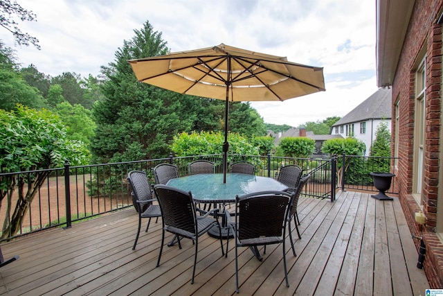 wooden terrace with outdoor dining space