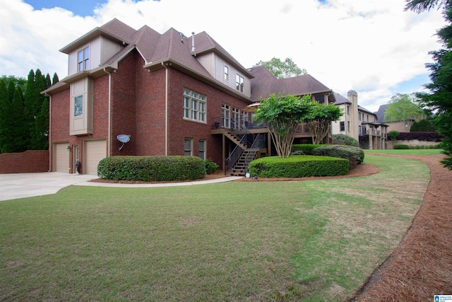 view of front of property with stairs, a garage, concrete driveway, a deck, and a front yard