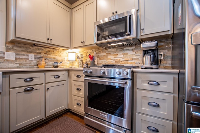 kitchen with light countertops, appliances with stainless steel finishes, and backsplash