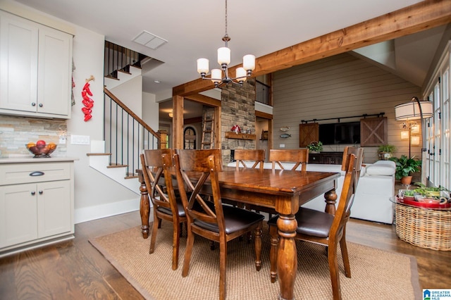 dining space featuring visible vents, stairway, lofted ceiling with beams, an inviting chandelier, and dark wood-type flooring